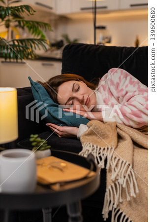Adult woman exhausted after hard work day lies down on pillow closes eyes falls asleep at night calm 139600680