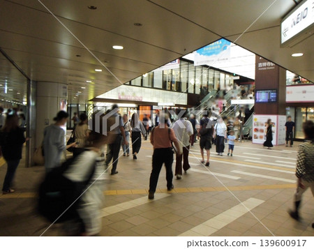 People walking through the station towards the exit People walking through the station towards the exit 139600917