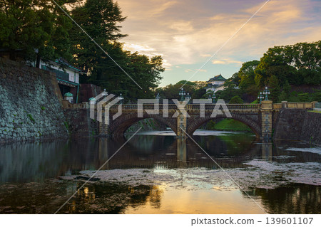 Tokyo, Japan - Oct 1 2024, A panoramic view of Nijubashi Bridge leading to main entrance of the Tokyo Imperial Palace grounds, with evening sky and colorful clouds in the background, Tokyo, Japan Tokyo, Japan - Oct 1 2024, A panoramic view of Nijubashi Bridge leading to main entrance of the Tokyo Imperial Palace grounds, with evening sky and colorful clouds in the background, Tokyo, Japan 139601107