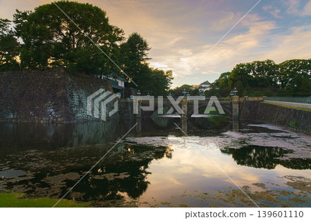 Tokyo, Japan - Oct 1 2024, A panoramic view of Nijubashi Bridge leading to main entrance of the Tokyo Imperial Palace grounds, with evening sky and colorful clouds in the background, Tokyo, Japan Tokyo, Japan - Oct 1 2024, A panoramic view of Nijubashi Bridge leading to main entrance of the Tokyo Imperial Palace grounds, with evening sky and colorful clouds in the background, Tokyo, Japan 139601110