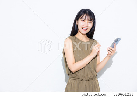 Young woman looking at her smartphone Young woman looking at her smartphone 139601235