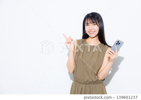 Young woman looking at her smartphone Young woman looking at her smartphone 139601237