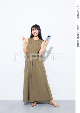 Young woman looking at her smartphone Young woman looking at her smartphone 139601239