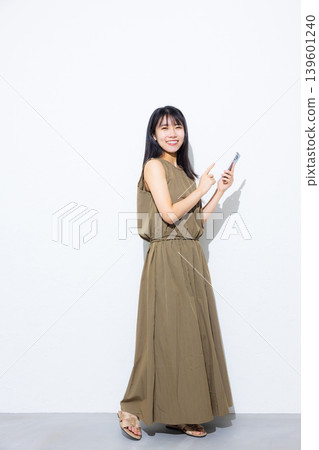 Young woman looking at her smartphone Young woman looking at her smartphone 139601240