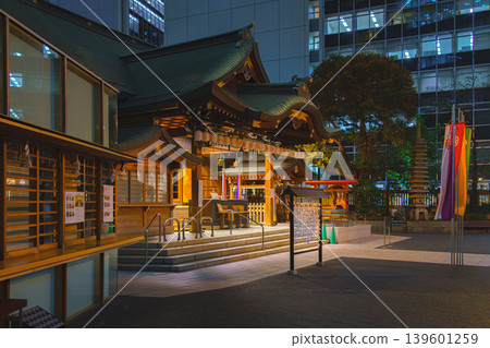 Tokyo, Japan - Oct 1 2024, A panoramic view of the Toranomono Kotohiragu Shinto shrine in the evening, with old street lamp glowing on foreground, office building on background, Tokyo, Japan Tokyo, Japan - Oct 1 2024, A panoramic view of the Toranomono Kotohiragu Shinto shrine in the evening, with old street lamp glowing on foreground, office building on background, Tokyo, Japan 139601259