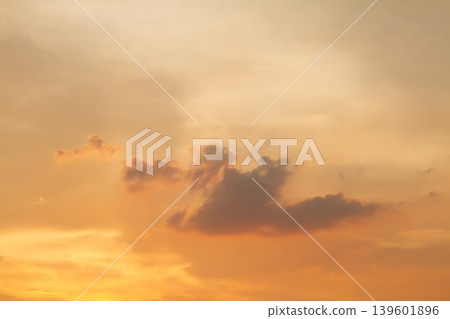 Beautiful orange sunset sky with soft drifting clouds and glowing evening light, creating a tranquil atmospheric background with warm natural colors. Beautiful orange sunset sky with soft drifting clouds and glowing evening light, creating a tranquil atmospheric background with warm natural colors. 139601896
