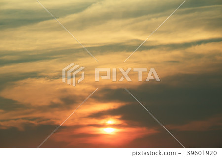 Vibrant sunset scene featuring layered clouds and glowing sunlight in warm golden tones, perfect for atmospheric backgrounds and tranquil nature themes. Vibrant sunset scene featuring layered clouds and glowing sunlight in warm golden tones, perfect for atmospheric backgrounds and tranquil nature themes. 139601920