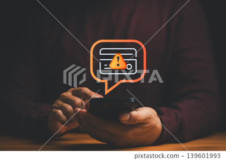 Credit card alert notification concept. Customer holding smartphone with warning message, symbolizing online payment error, scammer, digital banking security risk, and financial fraud prevention. Credit card alert notification concept. Customer holding smartphone with warning message, symbolizing online payment error, scammer, digital banking security risk, and financial fraud prevention. 139601993
