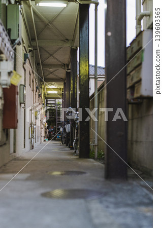 The common corridor and bicycles of an old apartment building The common corridor and bicycles of an old apartment building 139603565
