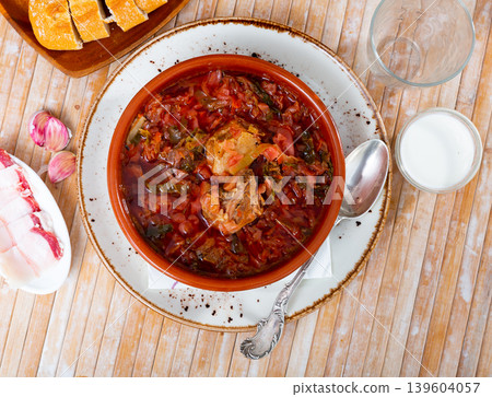 Borsch in bowl on table with salo and smetana Borsch in bowl on table with salo and smetana 139604057