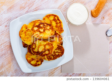 Tasty cheesecakes with sour cream on a plate Tasty cheesecakes with sour cream on a plate 139604061