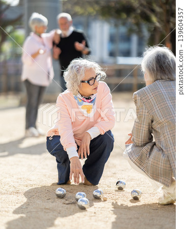Team of senior people playing petanque 139604357