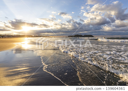 湘南久元沼海灘:江之島與清晨的陽光穿透雲層。 湘南久元沼海灘:江之島與清晨的陽光穿透雲層。 139604361