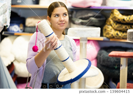 Young woman choosing cat scratching post for cats in pet shop 139604415