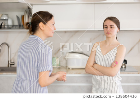 Quarrel between an mother and an adult daughter in kitchen 139604436