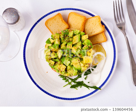 Salmon tartare with avocado and toasted bread Salmon tartare with avocado and toasted bread 139604456