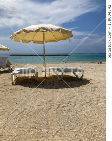 Blue sea and beach umbrella Blue sea and beach umbrella 139604542