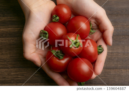 Mini tomatoes in my hand Mini tomatoes in my hand 139604887
