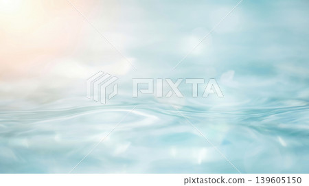A clear water surface and a softly lit, blurred background. 139605150