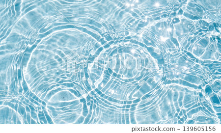 Ripples spreading across the clear blue water surface Ripples spreading across the clear blue water surface 139605156