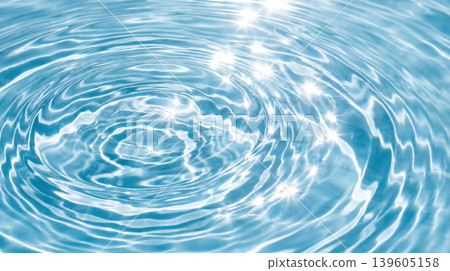 Ripples spreading across the clear blue water surface 139605158