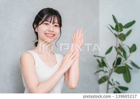 Japanese women applying hand cream to the back of their hands (skin care) Japanese women applying hand cream to the back of their hands (skin care) 139605217