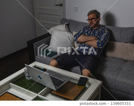 Frustrated employee sitting with crossed arms Frustrated employee sitting with crossed arms 139605331