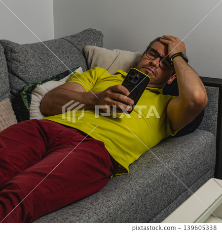 Man suffering from smartphone addiction late at night 139605338