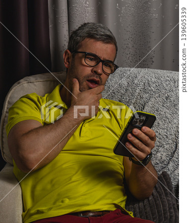 Man thinking deeply while reading smartphone content 139605339