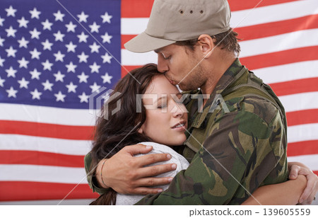 American soldier kiss woman, reunion after war and hug to welcome hero with love and flag. Army man reunite with partner, military veteran in uniform for homecoming with happiness and affection American soldier kiss woman, reunion after war and hug to welcome hero with love and flag. Army man reunite with partner, military veteran in uniform for homecoming with happiness and affection 139605559