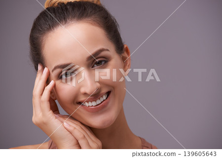Portrait, smile and beauty with woman on space in studio for skincare, wellness or natural cosmetics. Face, aesthetic and mockup with happy young person on gray background for natural dermatology Portrait, smile and beauty with woman on space in studio for skincare, wellness or natural cosmetics. Face, aesthetic and mockup with happy young person on gray background for natural dermatology 139605643