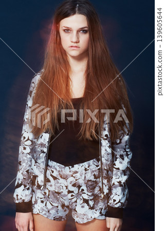 Portrait, fashion and a serious young woman in studio on a dark background for clothing style. Hair, flare and intense with a confident redhead model in a trendy, casual or relaxed clothes outfit Portrait, fashion and a serious young woman in studio on a dark background for clothing style. Hair, flare and intense with a confident redhead model in a trendy, casual or relaxed clothes outfit 139605644