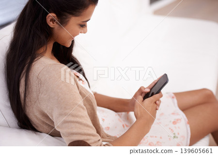 Happy woman, phone and typing on sofa for communication, social media or networking at home. Female person smile on mobile smartphone for online chatting, texting or search in living room at house 139605661