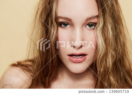 Woman, face and beauty with skin and hair, natural cosmetics with dermatology shine on beige background. Clean makeup, portrait and haircare with highlights, skincare and young model in studio Woman, face and beauty with skin and hair, natural cosmetics with dermatology shine on beige background. Clean makeup, portrait and haircare with highlights, skincare and young model in studio 139605719