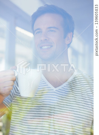 Man, coffee and thinking by window in home with smile, vision or idea with drink, choice and remember in morning. Person, tea cup and happy with view for memory, decision or relax on holiday in house Man, coffee and thinking by window in home with smile, vision or idea with drink, choice and remember in morning. Person, tea cup and happy with view for memory, decision or relax on holiday in house 139605833