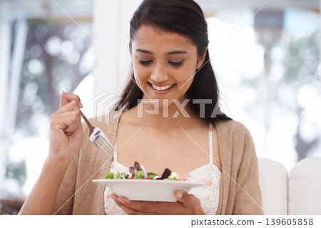 Happy woman, bowl and eating salad for diet, healthy snack or natural nutrition on sofa in living room at home. Female person, vegan or nutritionist smile with mix vegetables for weight loss at house Happy woman, bowl and eating salad for diet, healthy snack or natural nutrition on sofa in living room at home. Female person, vegan or nutritionist smile with mix vegetables for weight loss at house 139605858