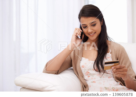 Happy woman, phone call and credit card for payment, online shopping or banking on sofa at home. Female person talking on mobile smartphone with smile for ecommerce, debit or conversation on account Happy woman, phone call and credit card for payment, online shopping or banking on sofa at home. Female person talking on mobile smartphone with smile for ecommerce, debit or conversation on account 139605878
