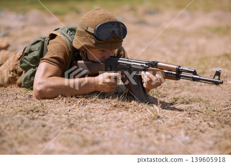 Military, sniper and shooting with man and gun in nature for war, conflict and patriotism. Army, surveillance and security with person and aim with rifle training for soldier, battlefield and veteran 139605918