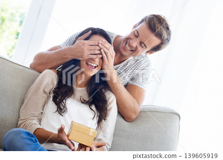 Surprise, cover eyes and couple in house with gift, love and playful in marriage with anniversary in home. Man, hands and woman face for present in relationship, together and celebrate in living room Surprise, cover eyes and couple in house with gift, love and playful in marriage with anniversary in home. Man, hands and woman face for present in relationship, together and celebrate in living room 139605919