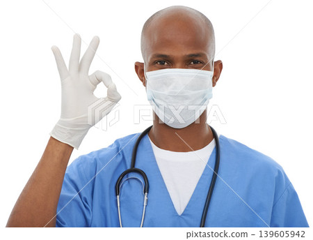 Face mask, perfect sign and portrait of doctor in a studio with glove and stethoscope for consultation. Virus, protection and African male healthcare worker with ok hand gesture by white background. Face mask, perfect sign and portrait of doctor in a studio with glove and stethoscope for consultation. Virus, protection and African male healthcare worker with ok hand gesture by white background. 139605942