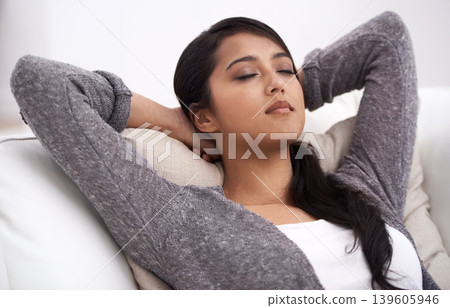 Woman, peace and hands behind head on couch in living room for happiness, relaxing and easy lifestyle in a home. Person enjoy nap on sofa, calming weekend and self care of mental health with mindset Woman, peace and hands behind head on couch in living room for happiness, relaxing and easy lifestyle in a home. Person enjoy nap on sofa, calming weekend and self care of mental health with mindset 139605946