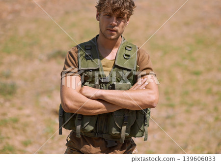 Military, arms crossed and portrait of man in nature for war, conflict and patriotism. Army, surveillance and security with person training on field for soldier, battlefield and veteran protection Military, arms crossed and portrait of man in nature for war, conflict and patriotism. Army, surveillance and security with person training on field for soldier, battlefield and veteran protection 139606033