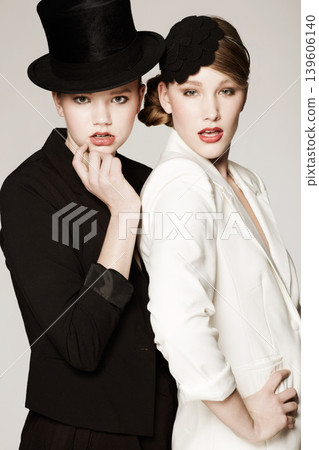 Women, fashion and models for portrait, pose and makeup with vintage clothes and studio background. Classic, retro and classy with glamour, stylish and jacket for lady, elegance or timeless outfit Women, fashion and models for portrait, pose and makeup with vintage clothes and studio background. Classic, retro and classy with glamour, stylish and jacket for lady, elegance or timeless outfit 139606140