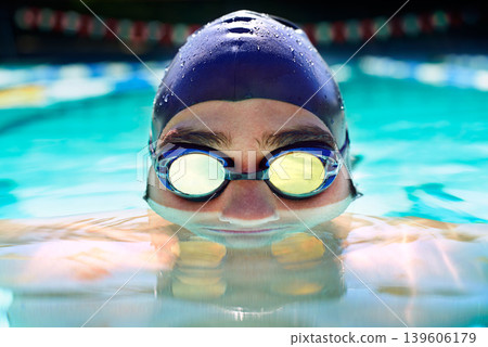 Swimming pool, goggles and sports man face for fitness exercise, outdoor workout or practice for race. Swimwear, wellness and wet swimmer doing waterpolo stroke, active cardio or training Swimming pool, goggles and sports man face for fitness exercise, outdoor workout or practice for race. Swimwear, wellness and wet swimmer doing waterpolo stroke, active cardio or training 139606179