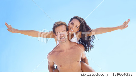 Portrait, freedom and piggyback with couple on beach together for holiday, vacation or romantic getaway. Smile, travel or summer with happy young man and woman by ocean or sea for coastal adventure Portrait, freedom and piggyback with couple on beach together for holiday, vacation or romantic getaway. Smile, travel or summer with happy young man and woman by ocean or sea for coastal adventure 139606352