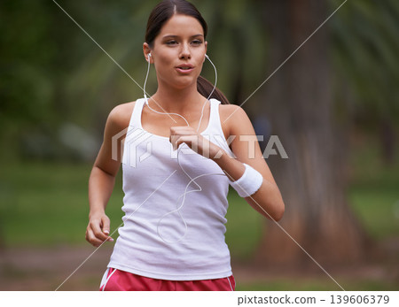 Music, runner and woman running in nature training, cardio exercise and endurance workout for wellness. Earphones, fitness or healthy sports athlete on jog on outdoors in forest with radio or podcast Music, runner and woman running in nature training, cardio exercise and endurance workout for wellness. Earphones, fitness or healthy sports athlete on jog on outdoors in forest with radio or podcast 139606379