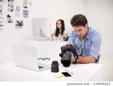 Camera, office and photographer looking at photoshoot in a studio or workshop for production. Creative, photography and young artist with dslr equipment for picture inspection in modern workplace. Camera, office and photographer looking at photoshoot in a studio or workshop for production. Creative, photography and young artist with dslr equipment for picture inspection in modern workplace. 139606402