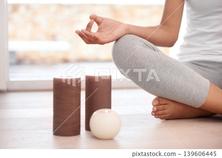Woman, hands and meditation by candles for zen, exercise or yoga in spiritual wellness or inner peace at home. Closeup of calm female person or yogi meditating in relax for awareness or mental health Woman, hands and meditation by candles for zen, exercise or yoga in spiritual wellness or inner peace at home. Closeup of calm female person or yogi meditating in relax for awareness or mental health 139606445