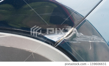 Damage of car. Dents on the edge of the car body and the rear bumper near the wheel arch. Damage of car. Dents on the edge of the car body and the rear bumper near the wheel arch. 139606631