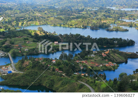 The breathtaking scenery of Lake Guatapé, Colombia: Green islands and blue lake waters as seen from El Peñón. The breathtaking scenery of Lake Guatapé, Colombia: Green islands and blue lake waters as seen from El Peñón. 139606827